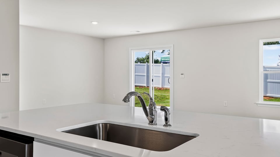 Kitchen with island and cabinets.