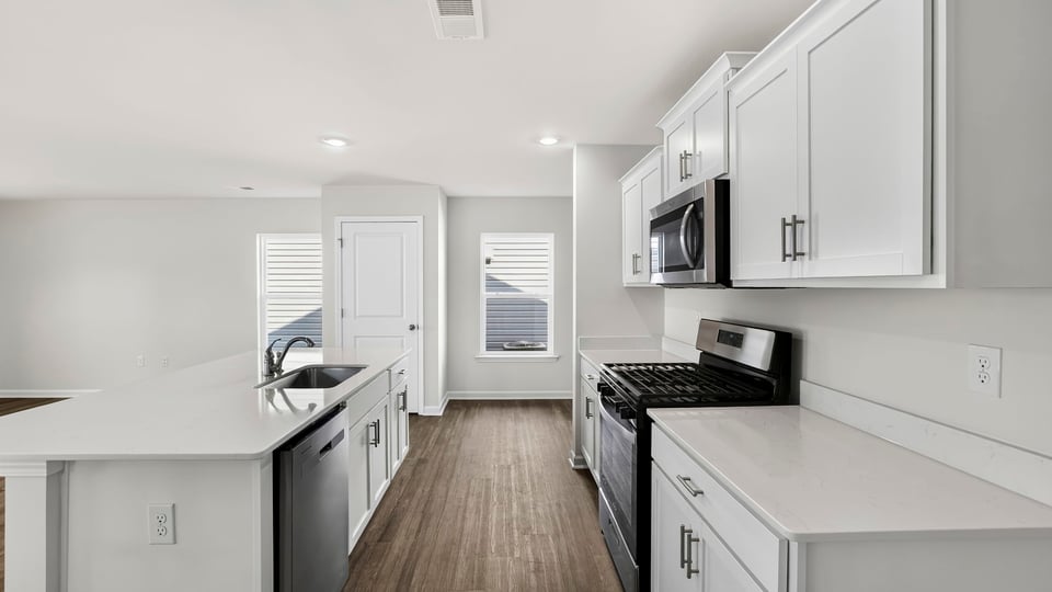Kitchen with island and cabinets.