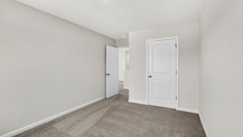Bedroom with carpet and windows.