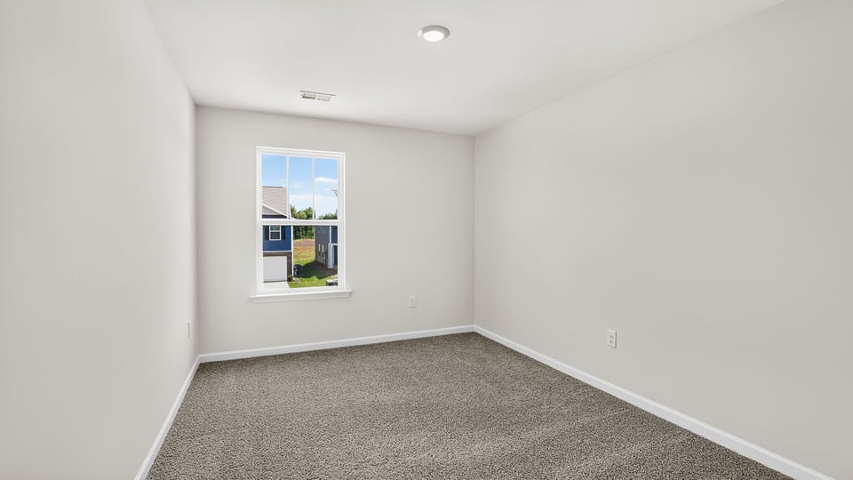 Bedroom with carpet and windows.