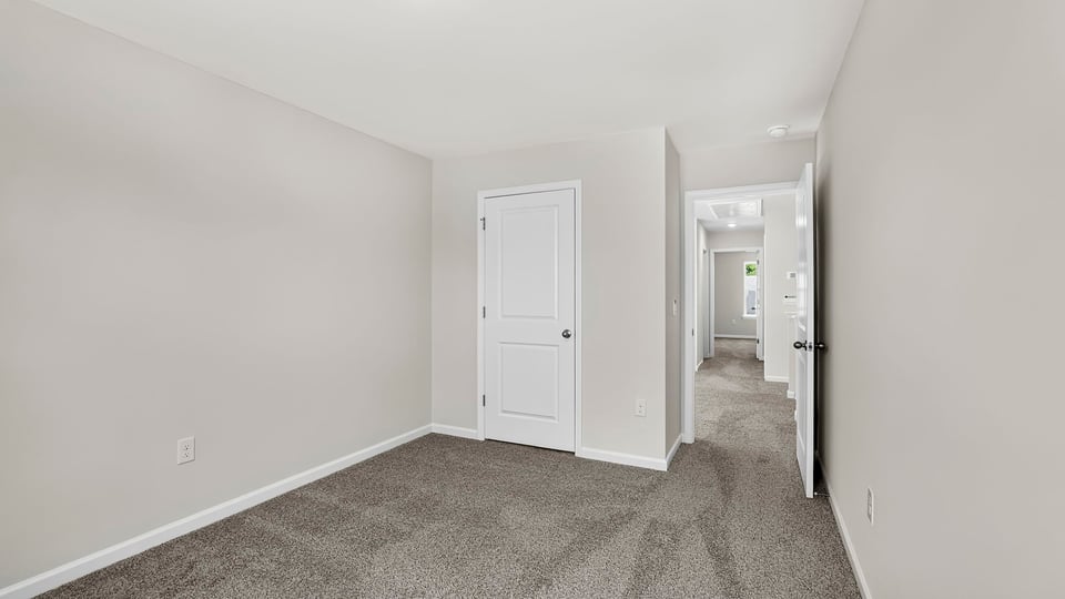 Bedroom with carpet and windows.