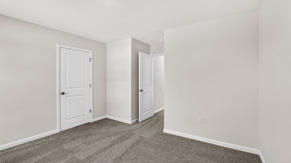 Bedroom with carpet and windows.