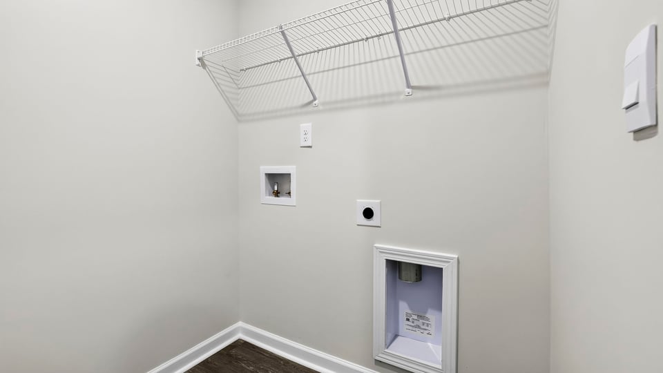 Laundry room with shelf.