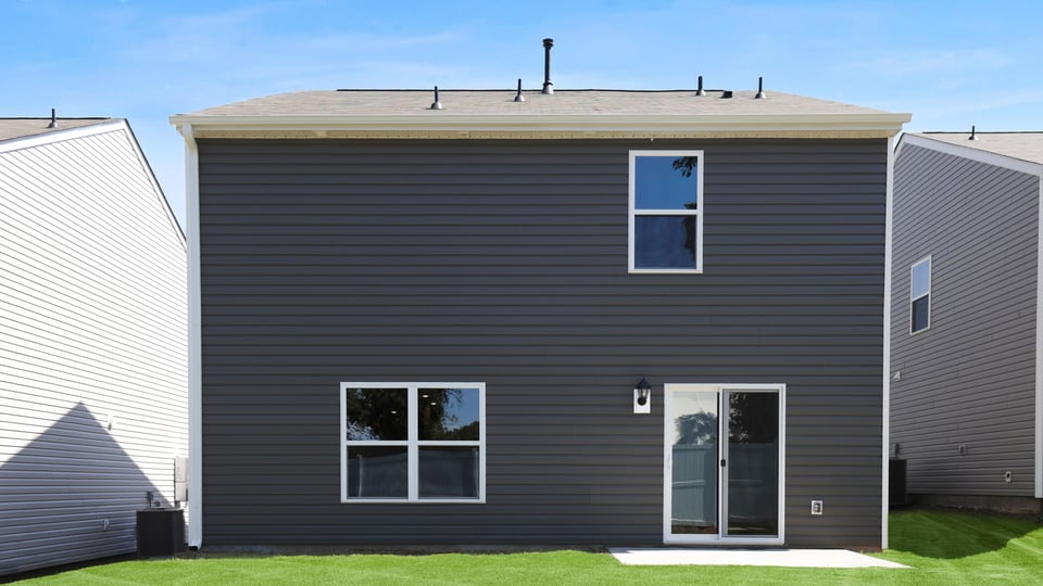 Back exterior with large backyard.