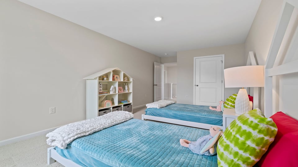Bedroom with carpet and windows.