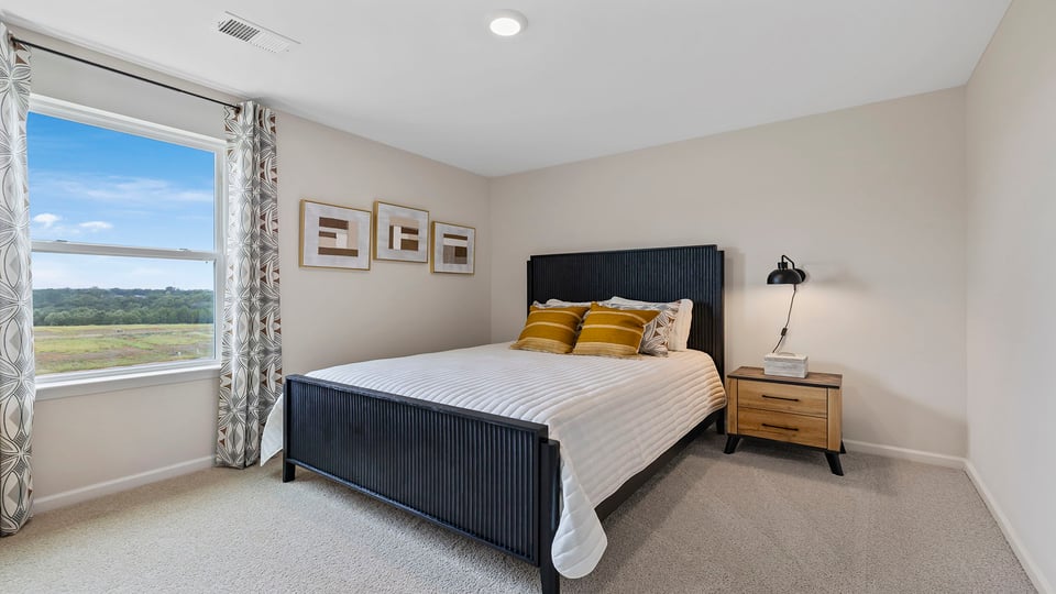 Bedroom with carpet and windows.