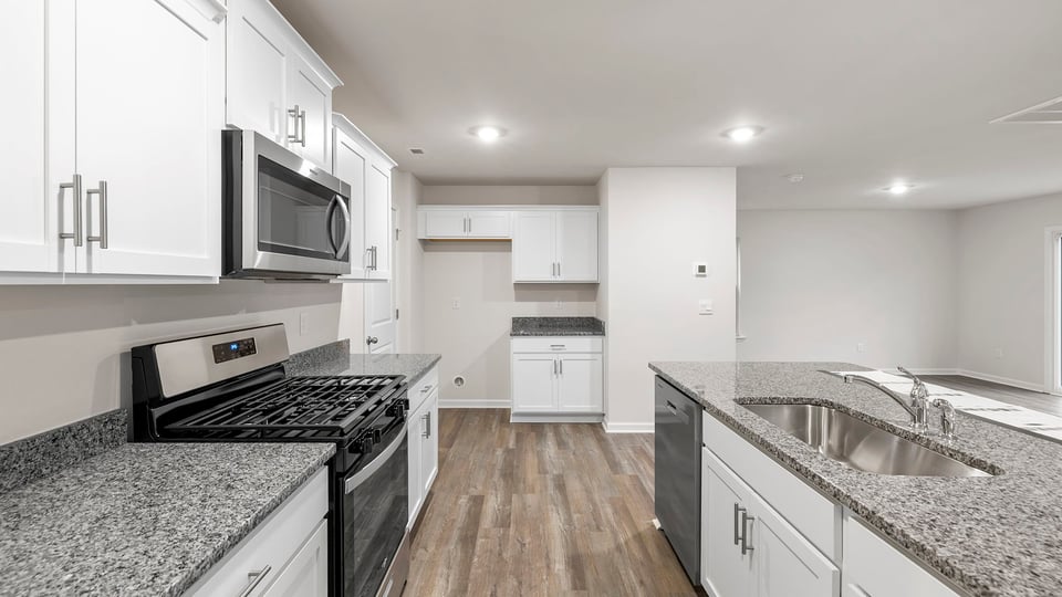 Kitchen and island have quartz countertops.