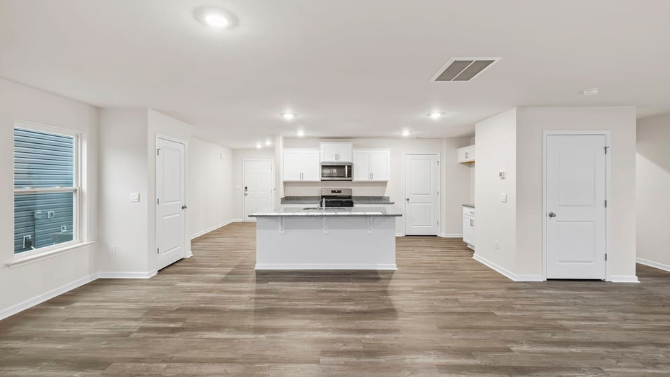 View of kitchen with island and recessed lighting.