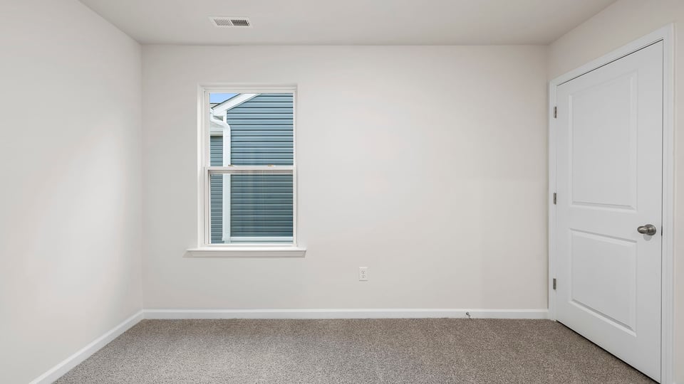 Loft area with window and carpet.