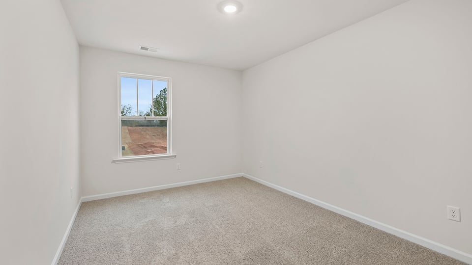 Bedroom with window and carpet.