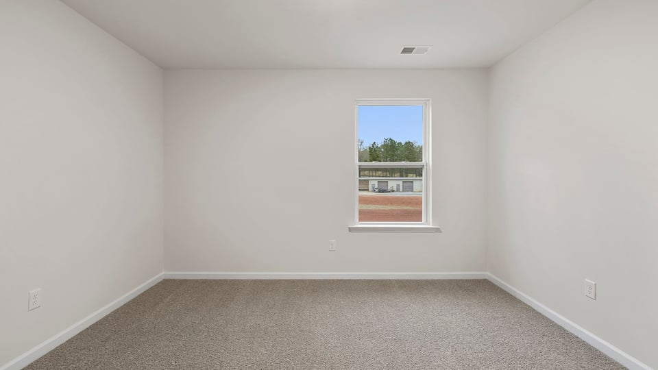 Bedroom with window and carpet.