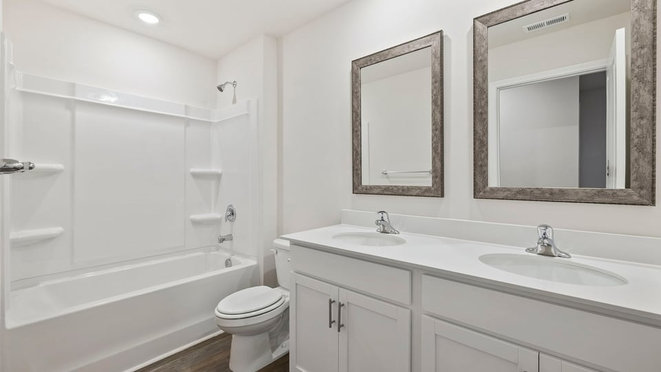 Hall bathroom with vanity and combination shower / tub.