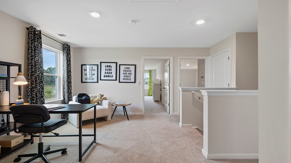 Loft area with carpet and windows.