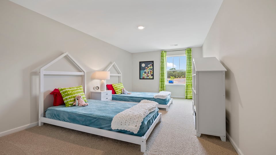 Bedroom with carpet and windows.