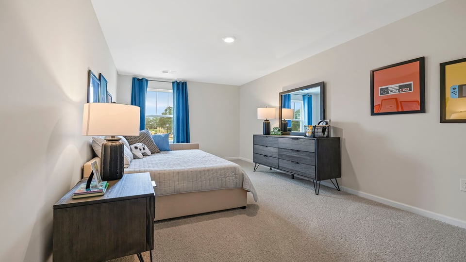 Bedroom with carpet and windows.