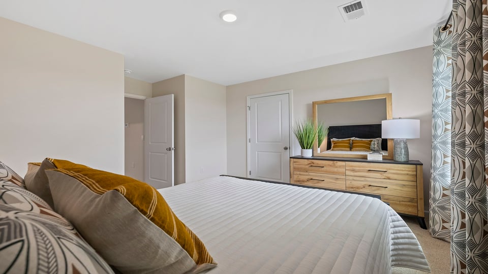 Bedroom with carpet and windows.
