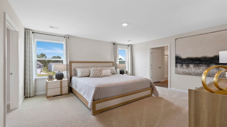 Bedroom with carpet and windows.