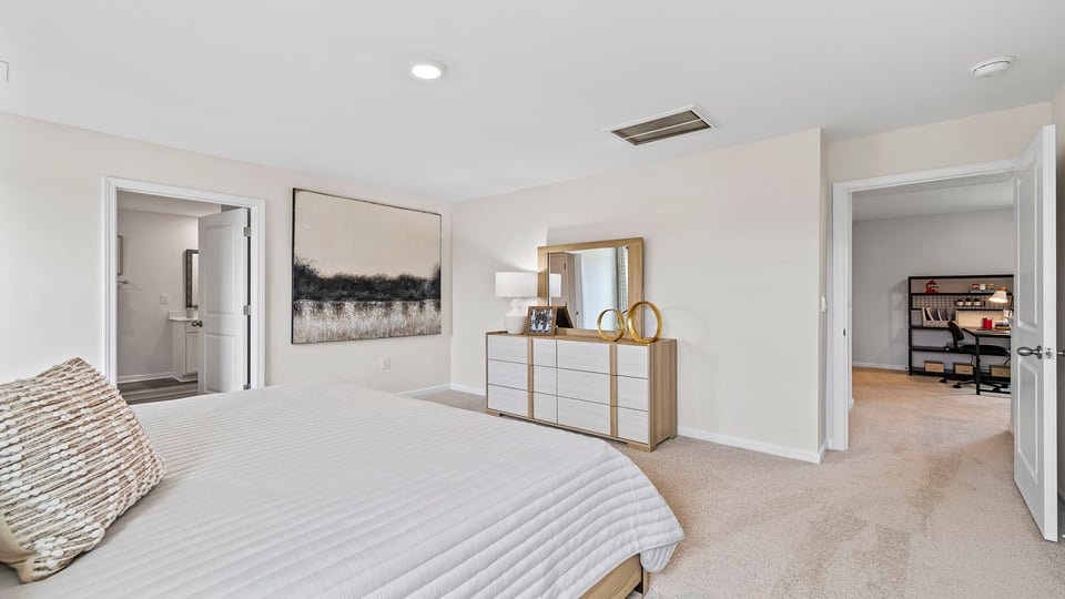 Bedroom with carpet and windows.
