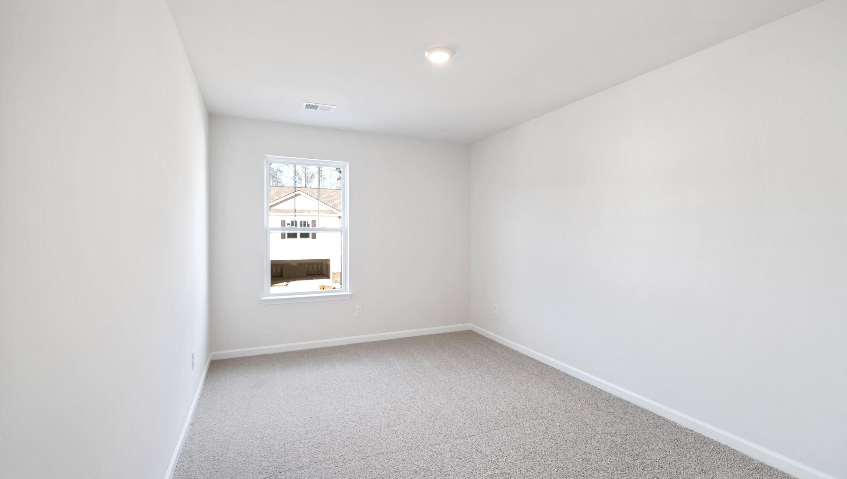 Bedroom with carpet and window.