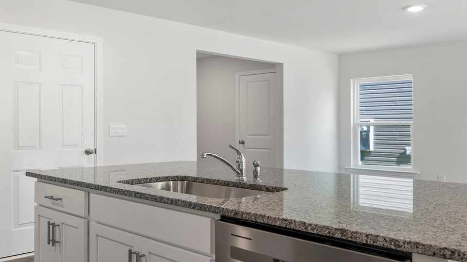 Island with sink and granite countertops.