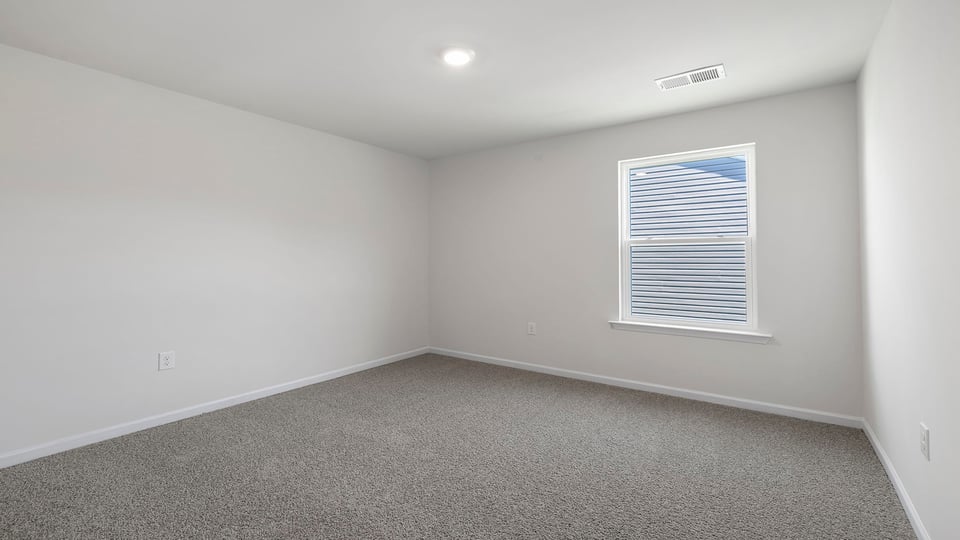 Bedroom with window and carpet.
