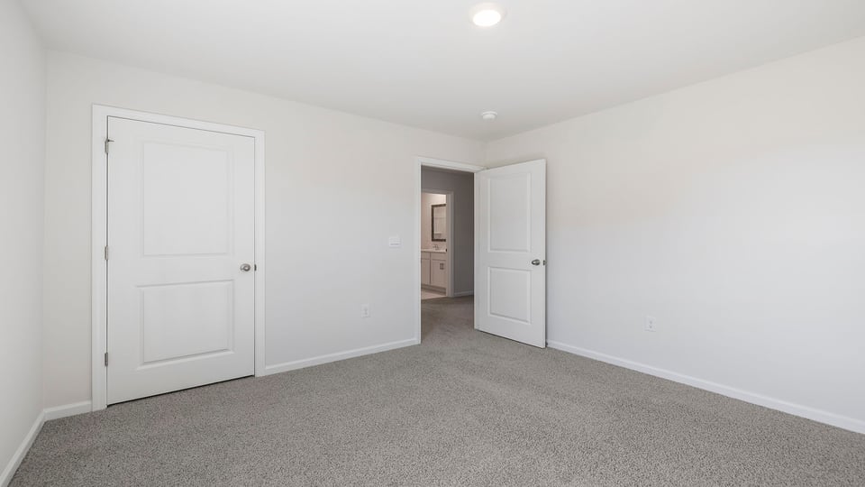 Bedroom with window and carpet.