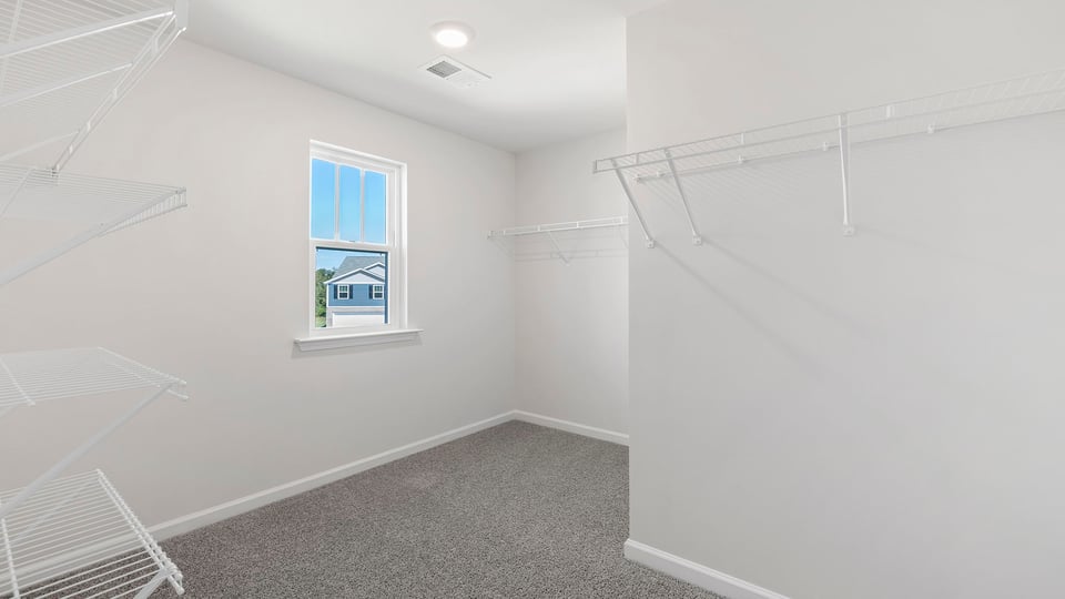 Primary bedroom with walk-in closet.