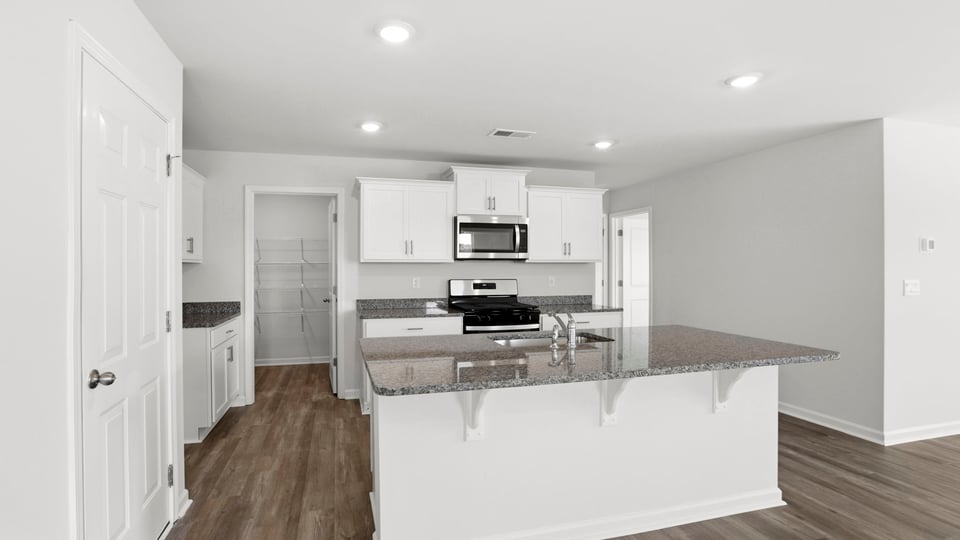Kitchen with island and cabinets.