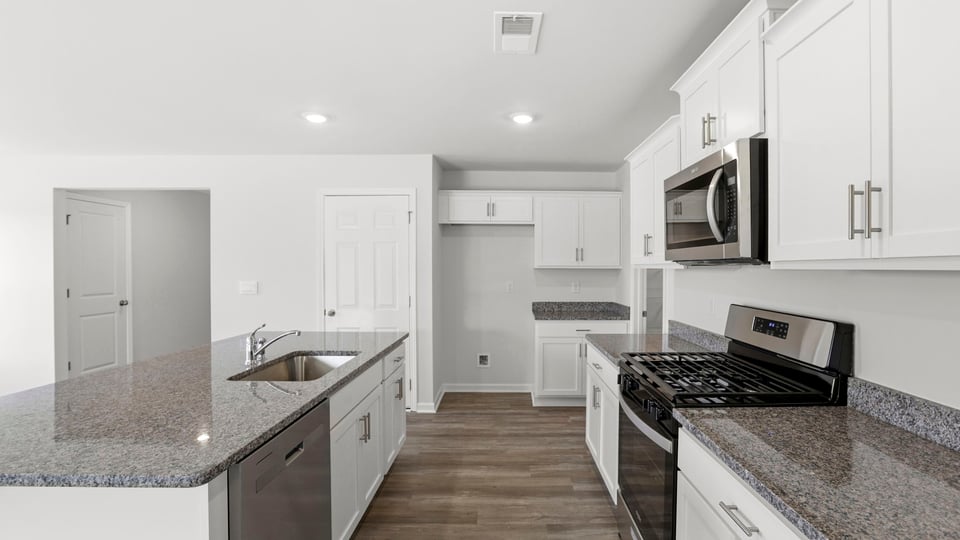 Kitchen with island and cabinets.