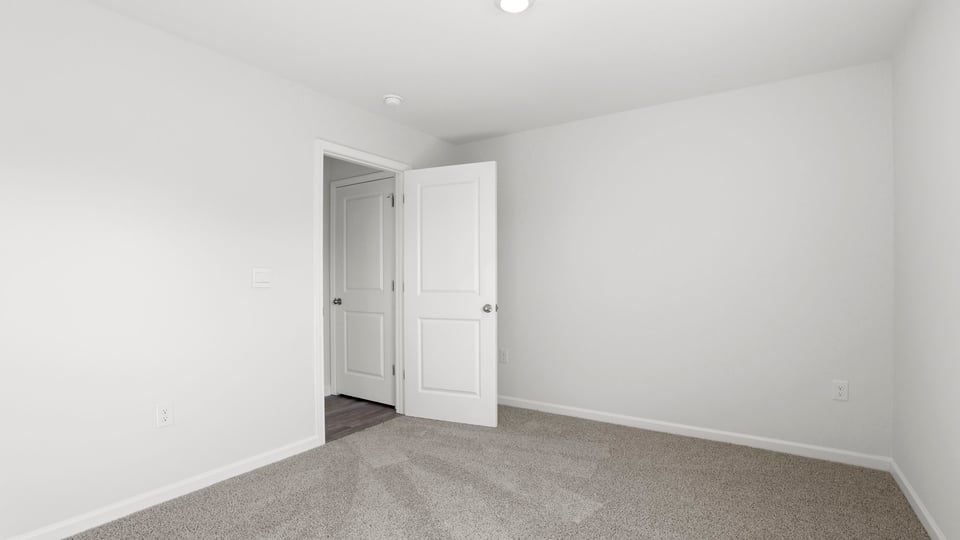 Bedroom with carpet and windows.