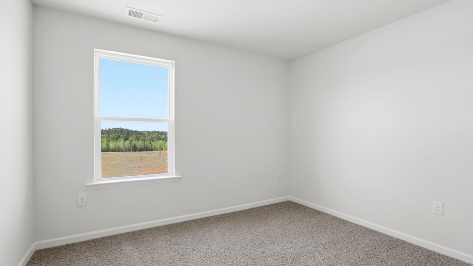 Bedroom with carpet and window.