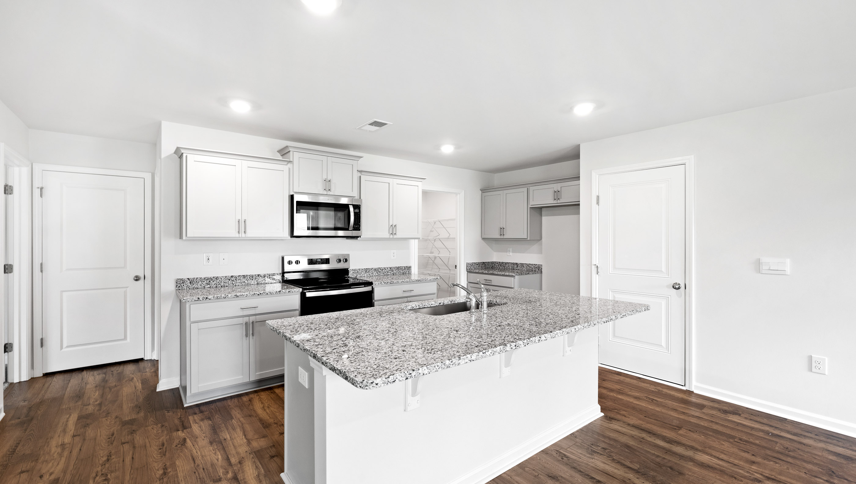 Kitchen with island and cabinets.