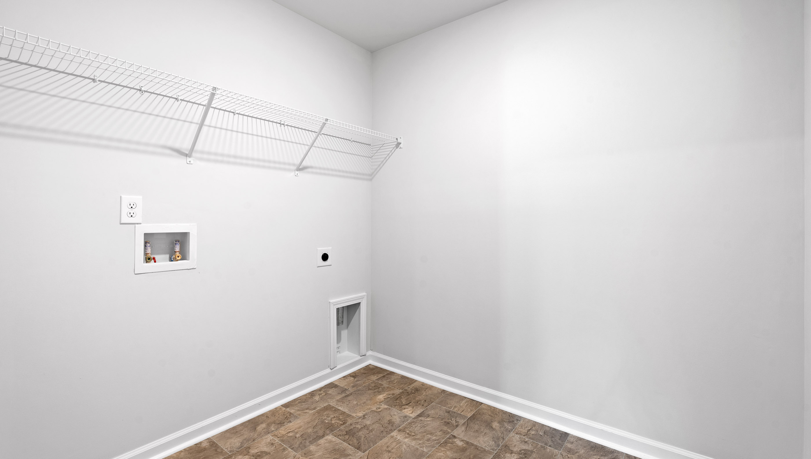 Laundry room with shelf.