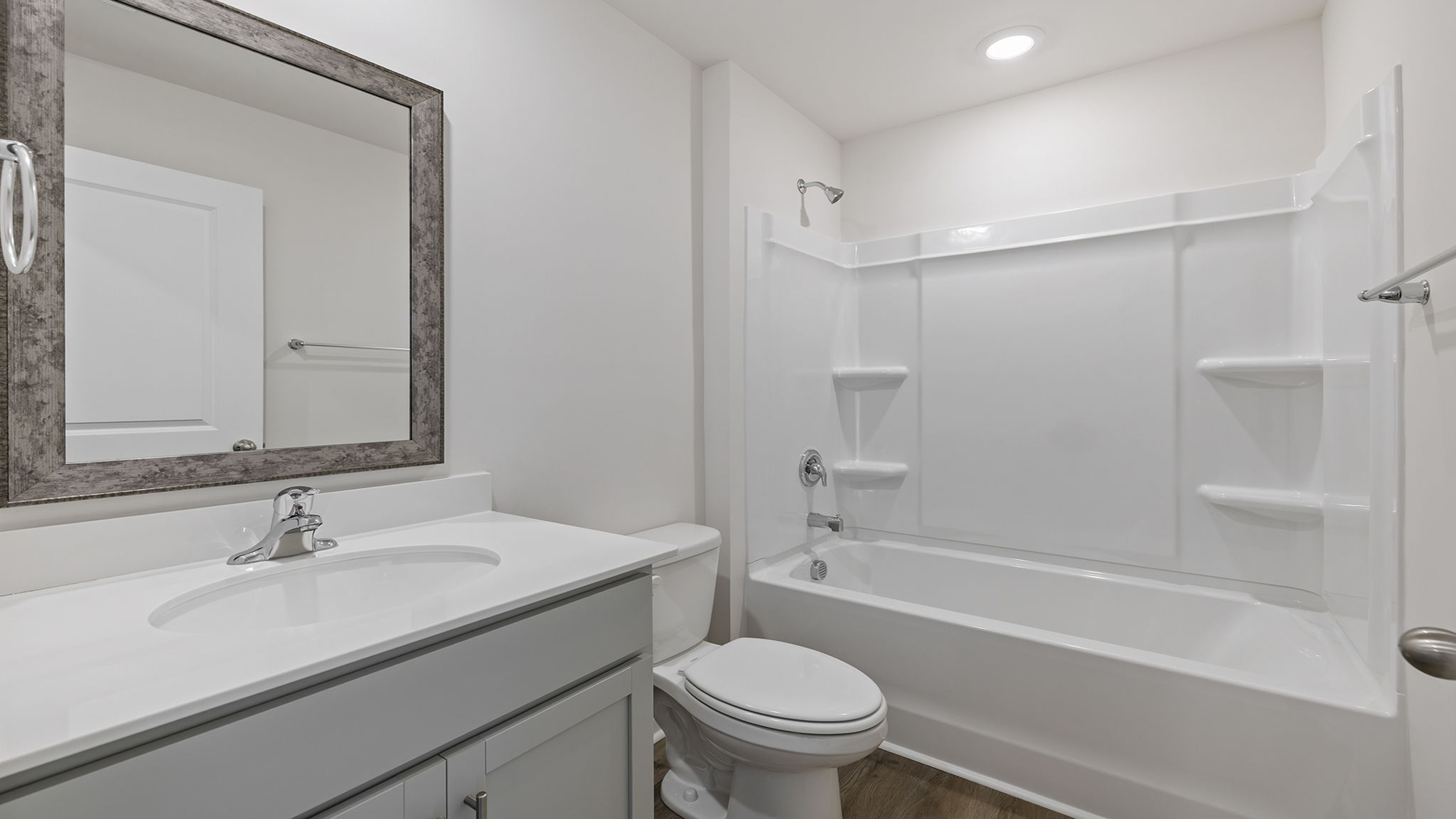 Hall bathroom with vanity and combination shower / tub.