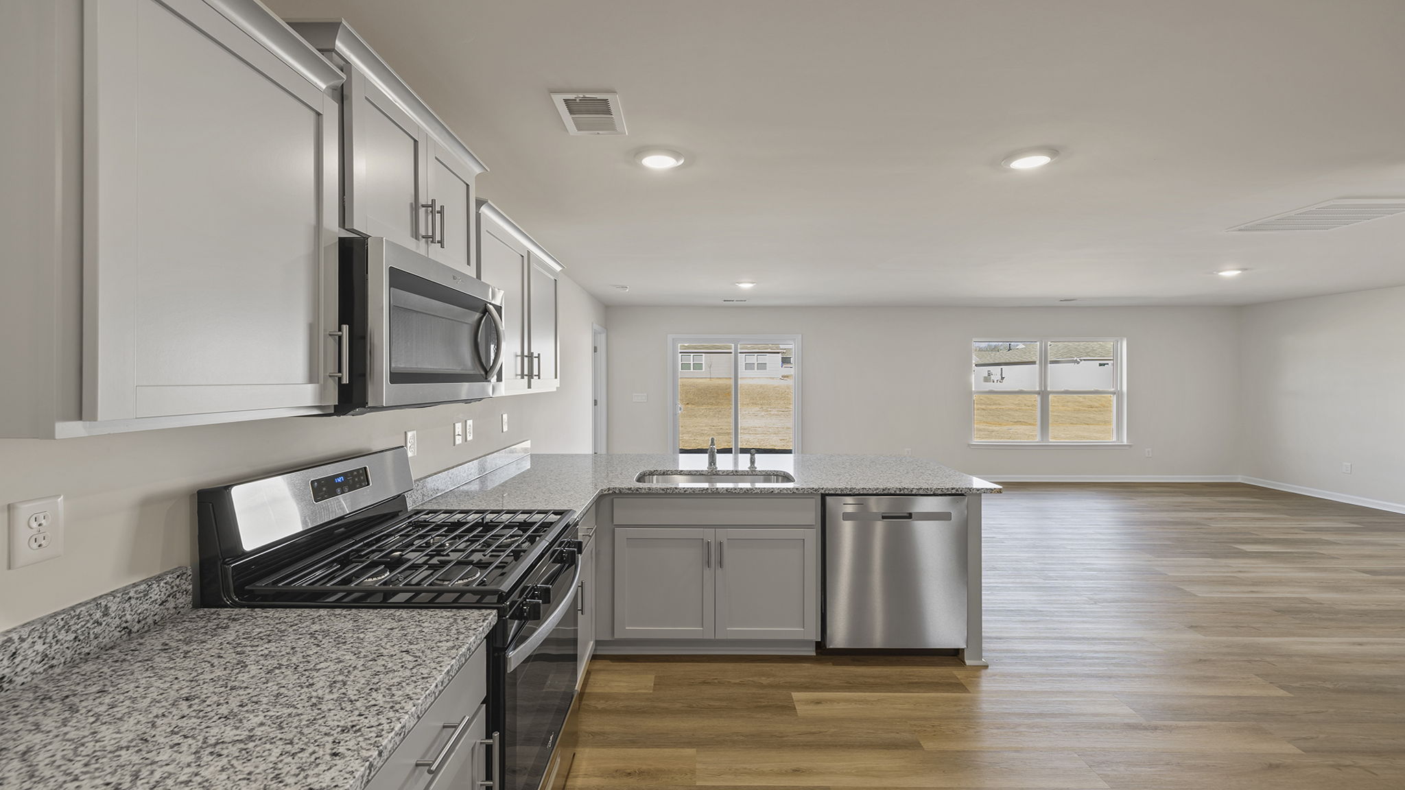 Kitchen has recessed lighting and quartz countertops.