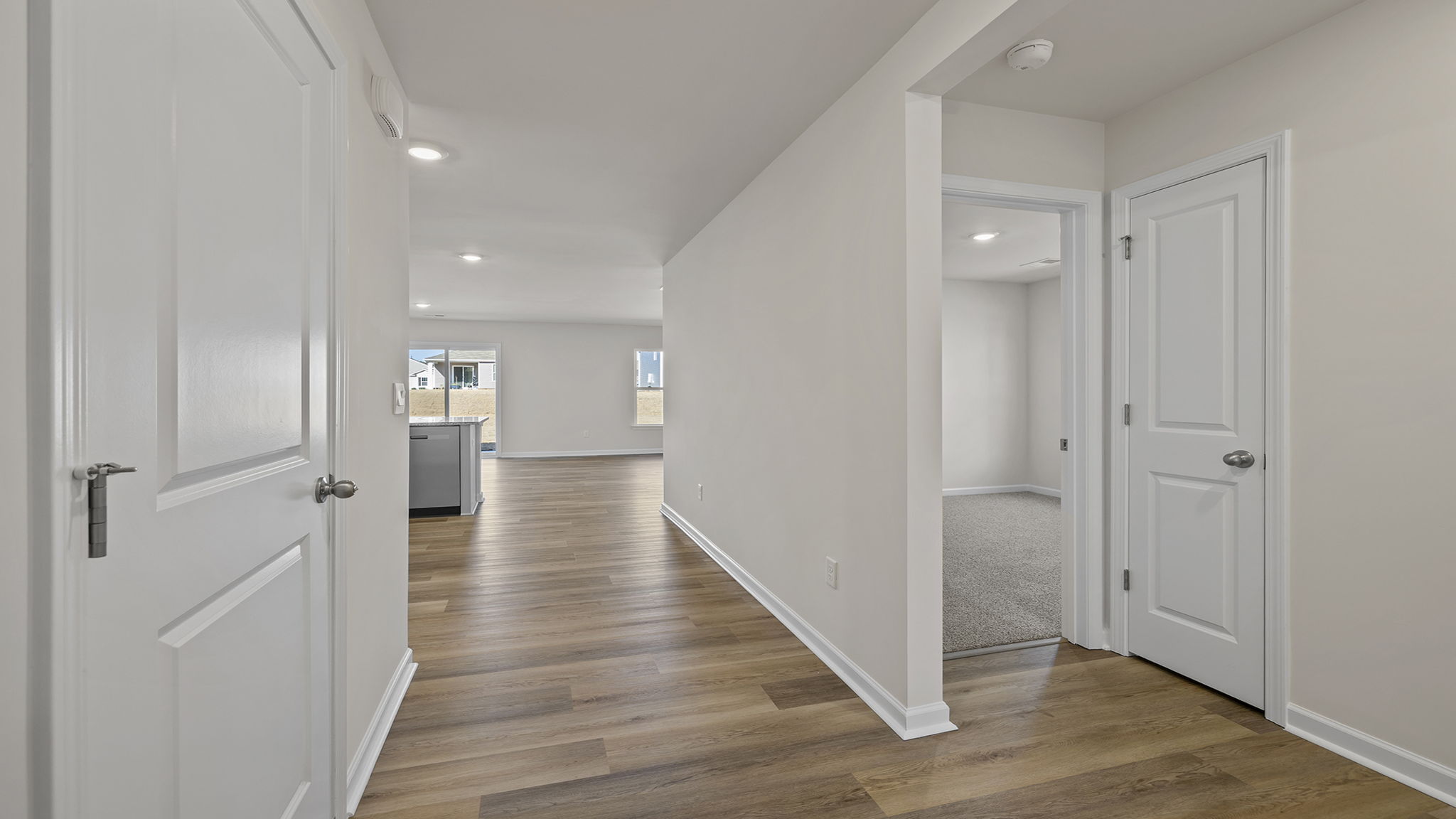 View from hallway of kitchen and open floor plan.