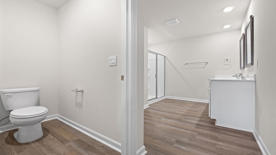 Bathroom with toilet and walk in shower.