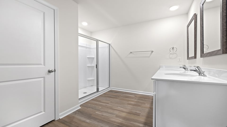 Bathroom with toilet and walk in shower.