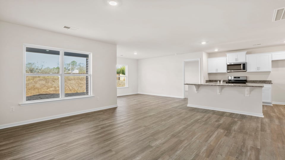 View from family room toward the open kitchen and dining area.