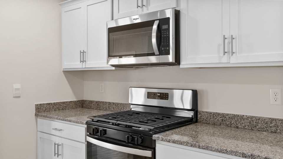 Kitchen features stainless steel appliances.