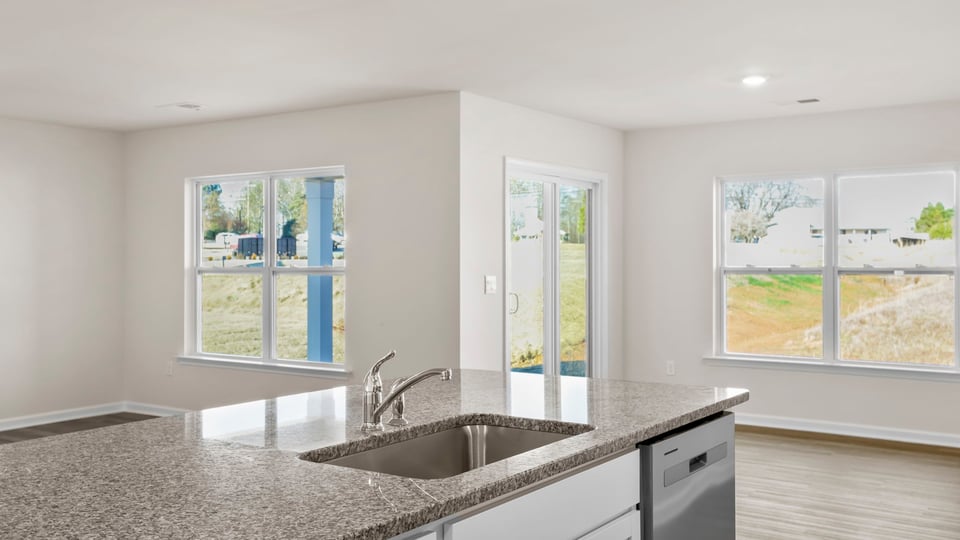 View from kitchen into dining and family rooms.
