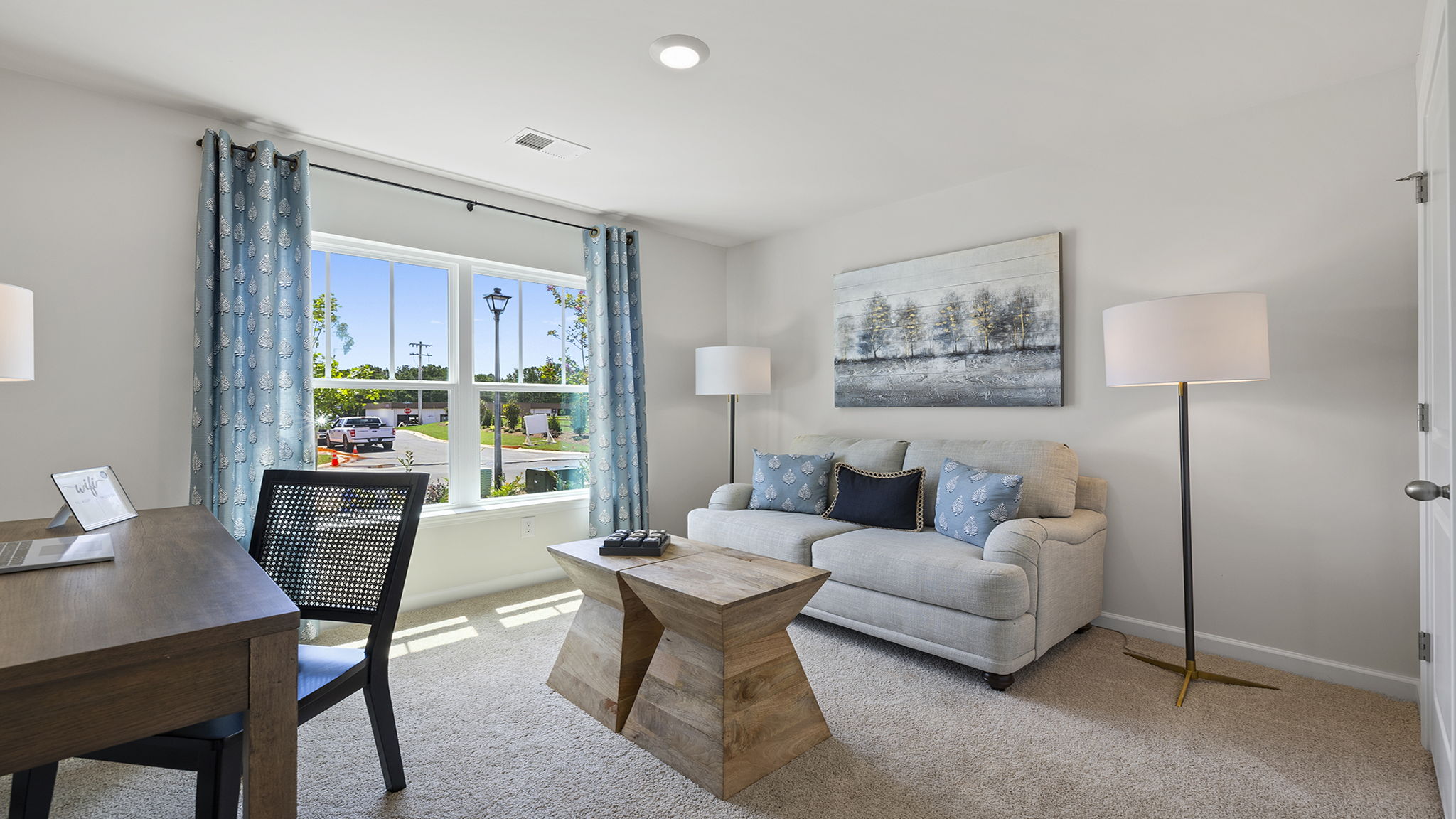 Bedroom with carpet and windows.