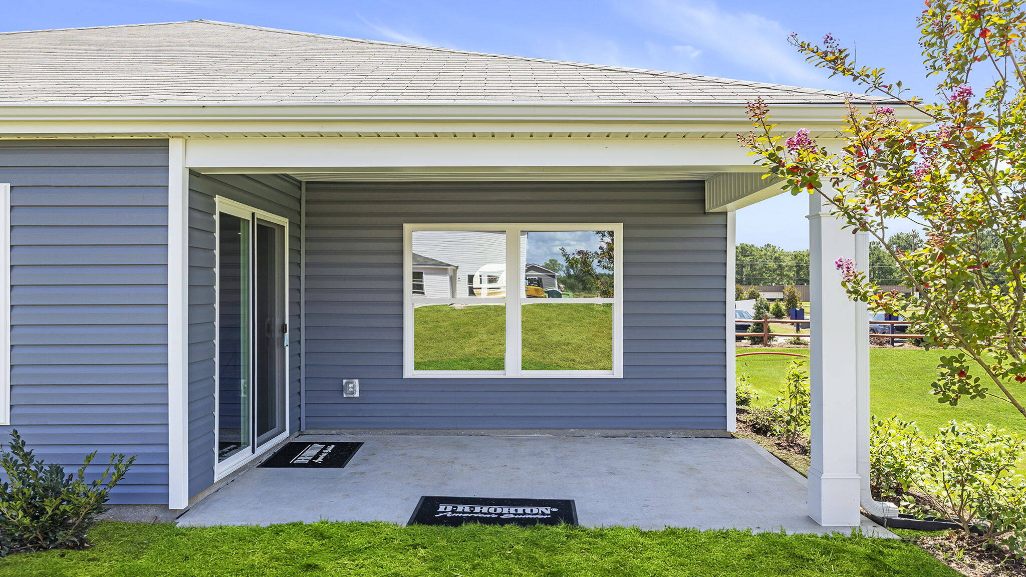Back exterior with covered patio.