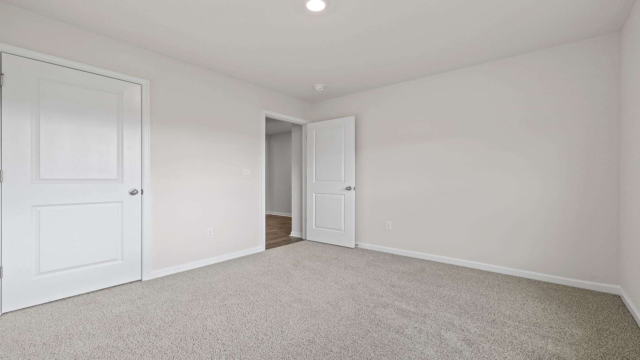 Bedroom with carpet and windows.