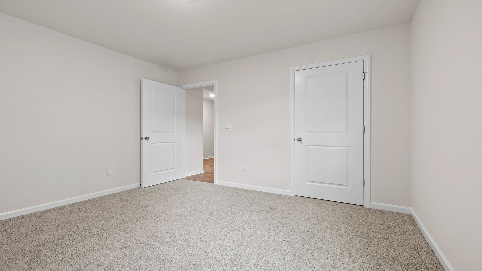Bedroom with carpet and windows.