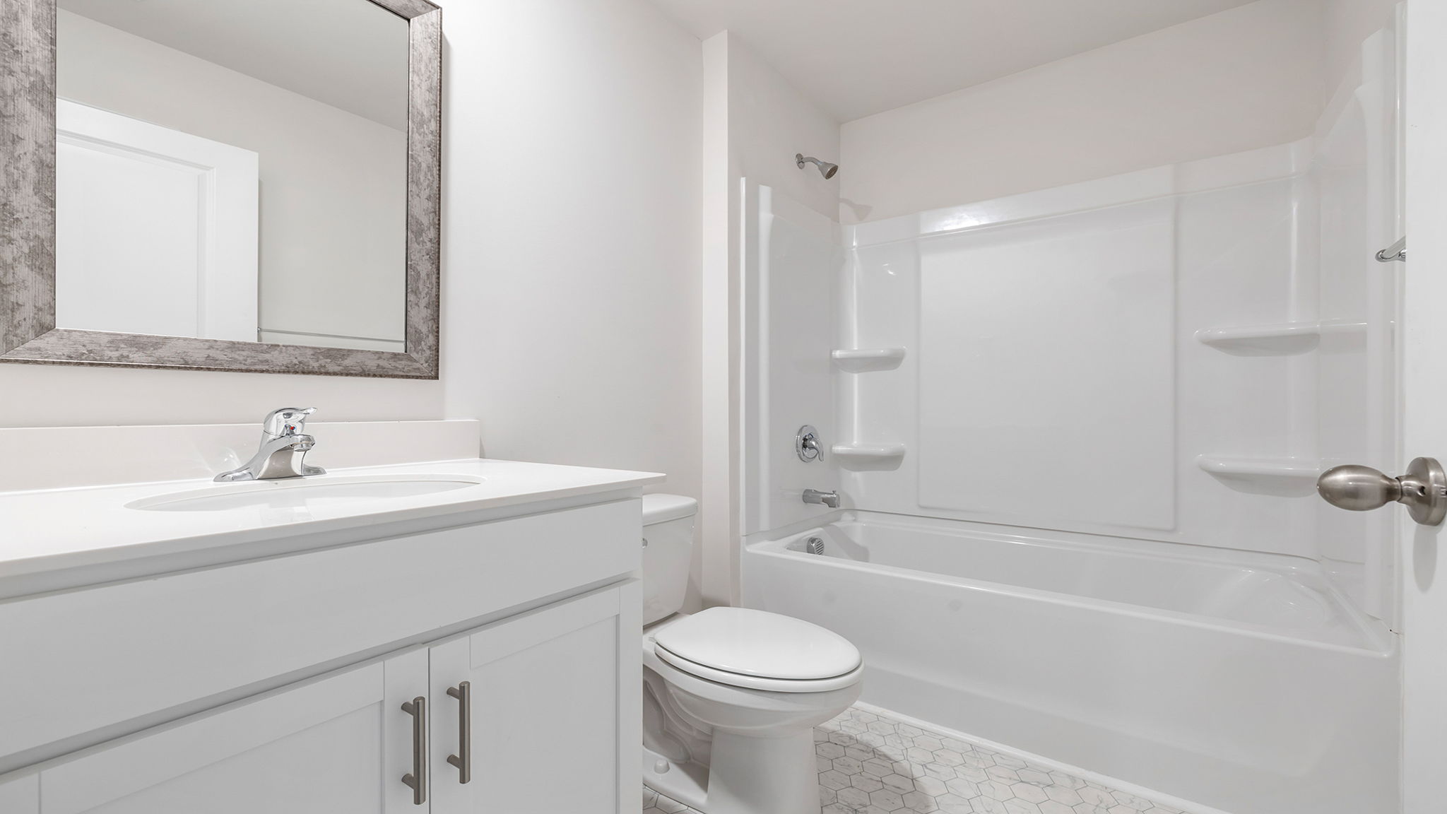 Hall bathroom with vanity and combination shower / tub.