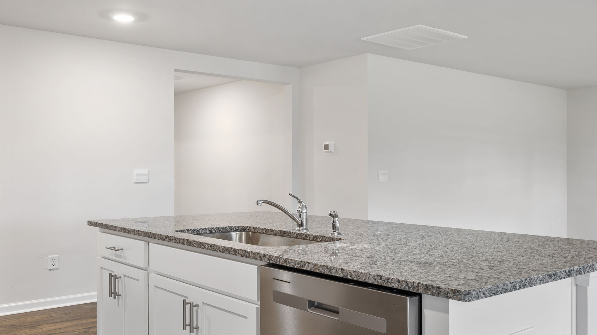 Kitchen island hosts sink and dishwasher.