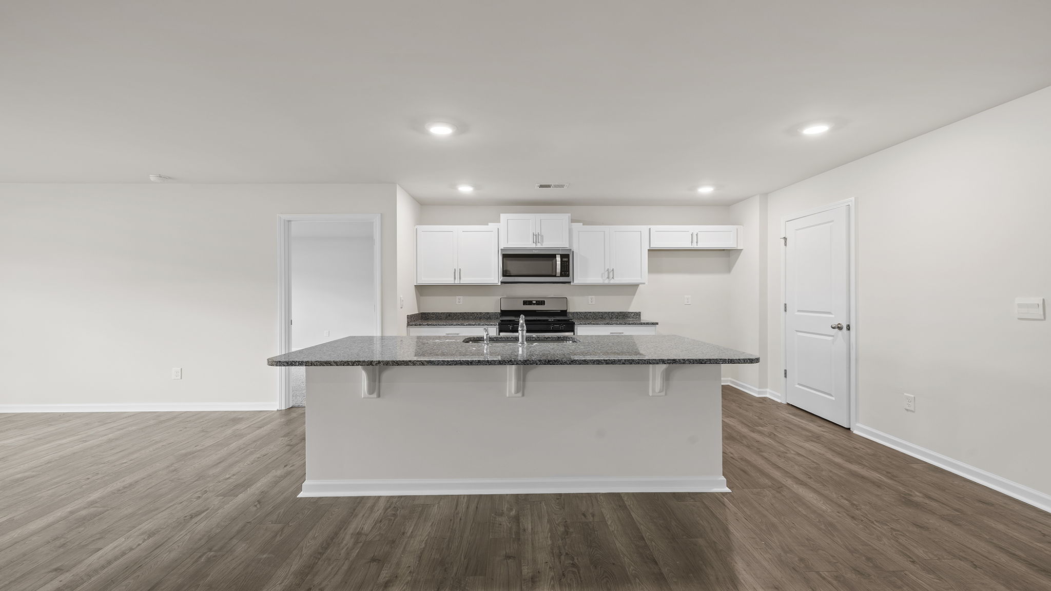 Open and efficient kitchen with recessed lighting.
