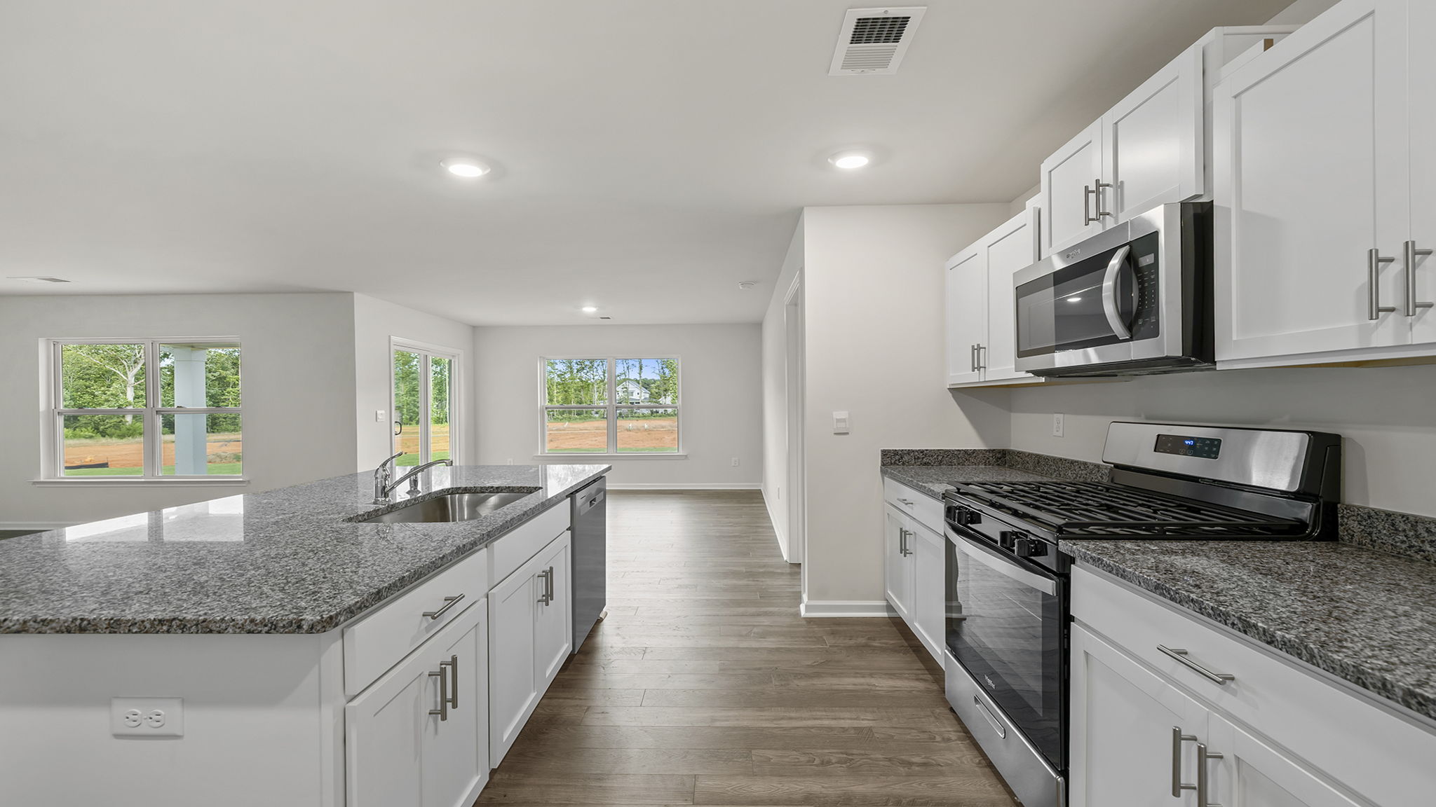 Kitchen and island have quartz countertops.
