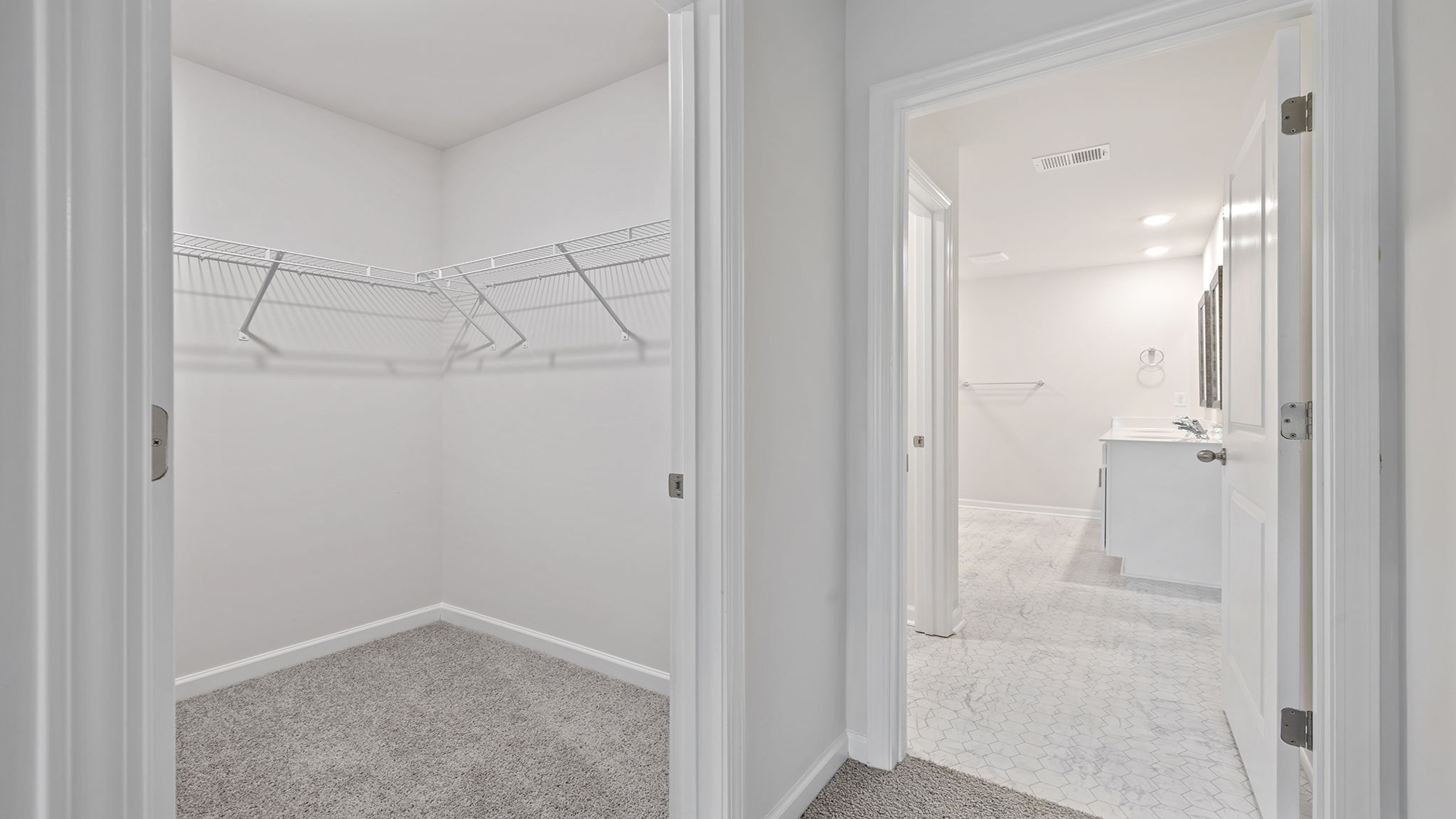 Primary bedroom walk in closet.